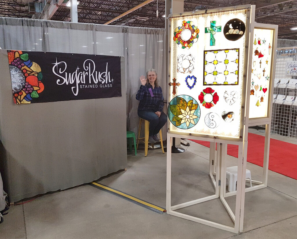 Juanita Sims displaying her stained glass artwork at 2022 London Christmas Craft Show